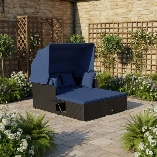 The rattan daybed with canopy set up in a garden patio area surrounded by plants