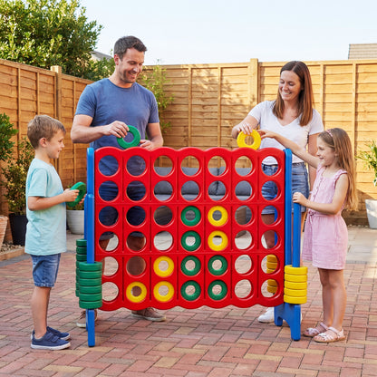 Family playing the giant four-in-a-row game set on a patio outdoors