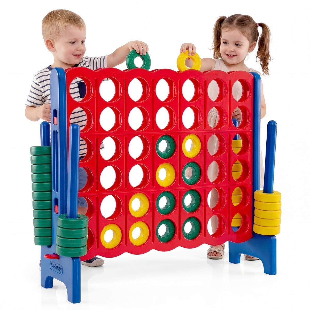 Two children playing the giant four-in-a-row game set indoors