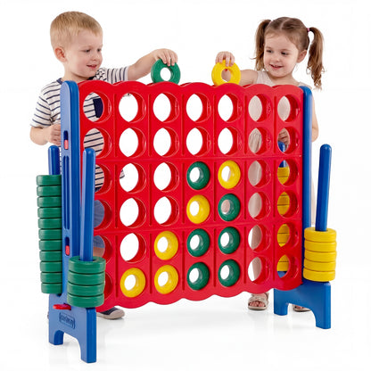 Two children playing the giant four-in-a-row game set indoors