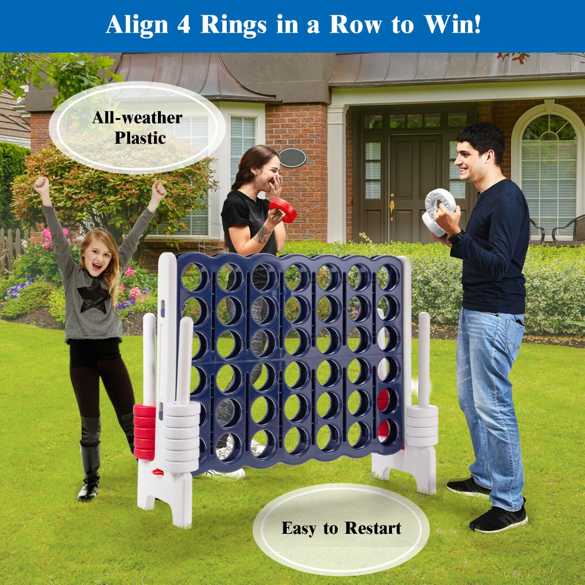 The lawn game being played by a family in a grassy garden in front of a brick house
