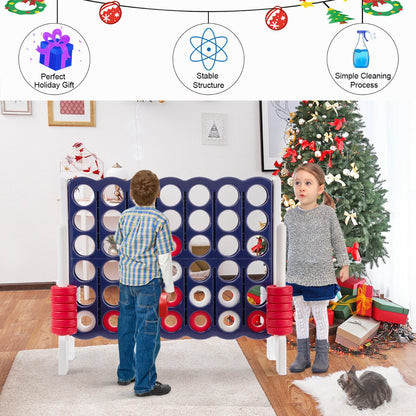 The lawn game standing in a living room next to a decorated Christmas tree with a young boy