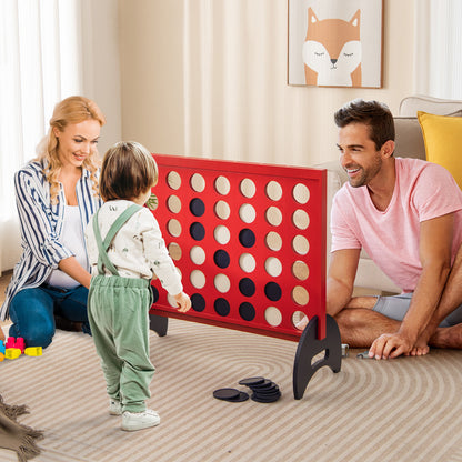 A family plays the giant four-in-a-row game indoors