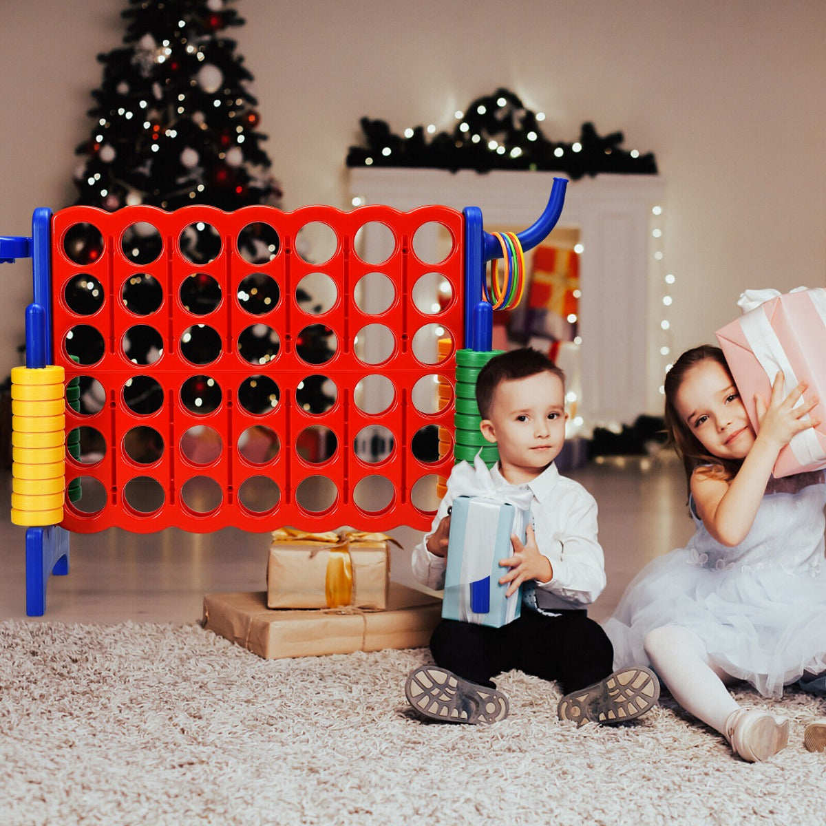 The lawn game positioned in a living room near a Christmas tree with two children