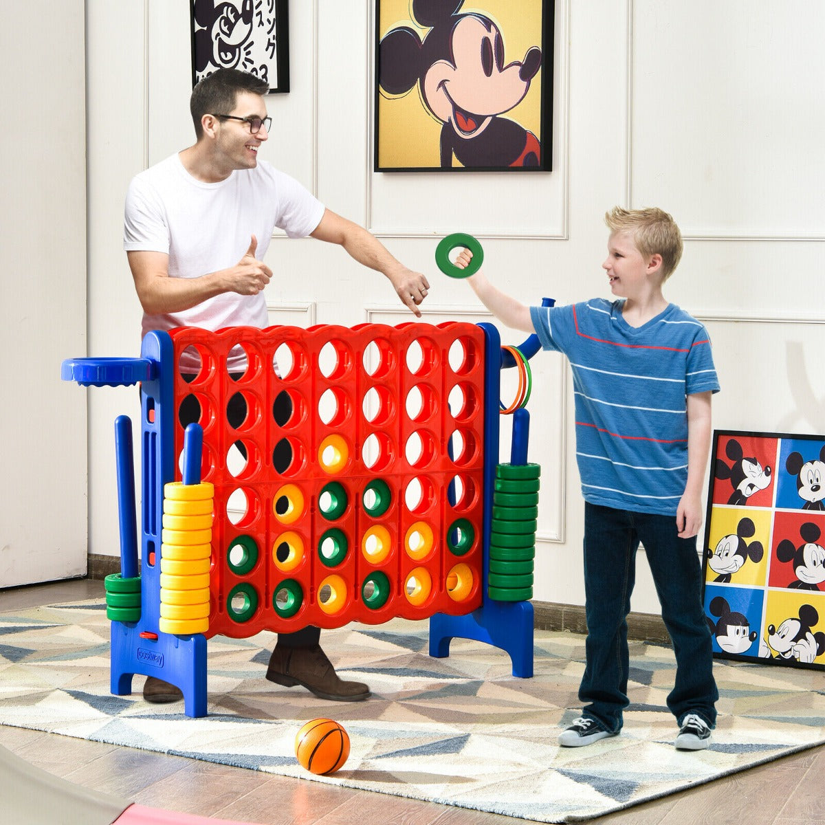 The lawn game being used by a man and a boy playing with a ring and a basketball