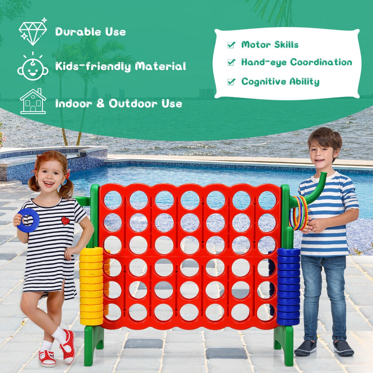 Children playing the giant connect four game outdoors by a swimming pool