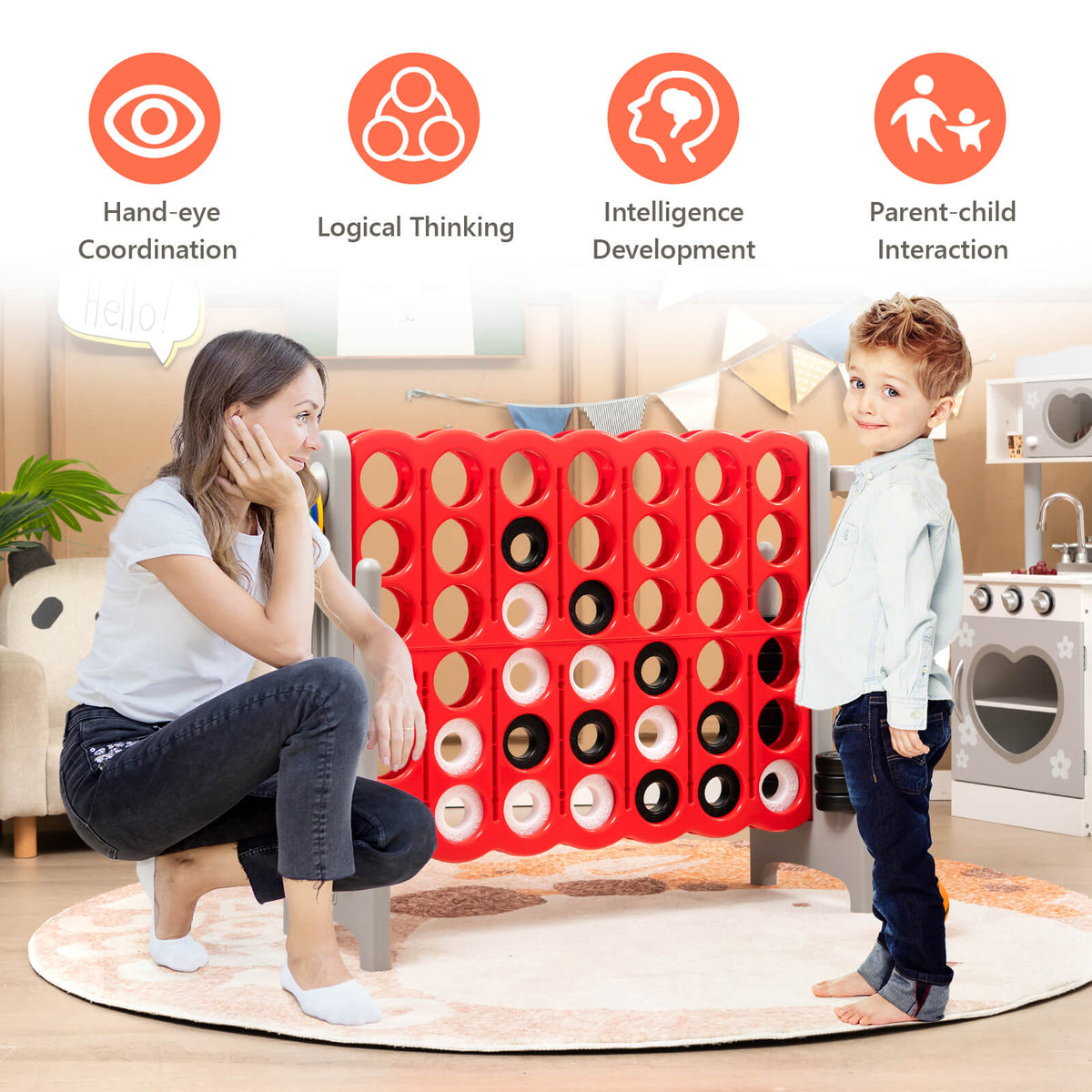 A woman and child playing the giant Connect 4 game indoors on a rug