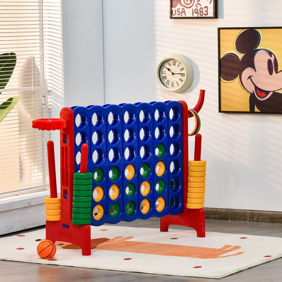 The lawn game placed on a patterned rug in a room with a clock and wall art