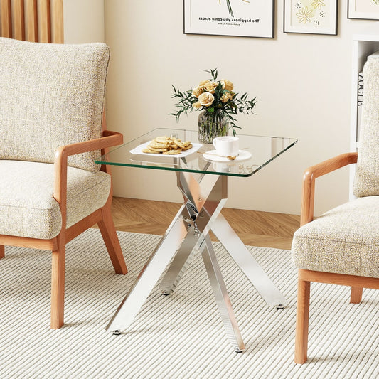The end table is set up in a living room with a vase of flowers and some biscuits on top
