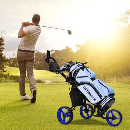 The golf trolley standing on a green course while a golfer swings a club