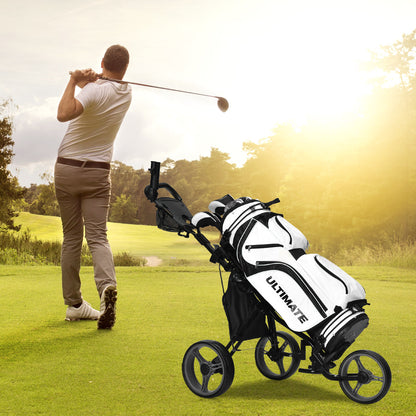 The golf trolley holding a bag on a sunny golf course while a person plays a shot