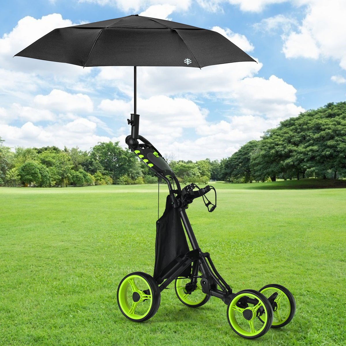 The golf trolley standing on a grassy field with a black umbrella attached to the handle