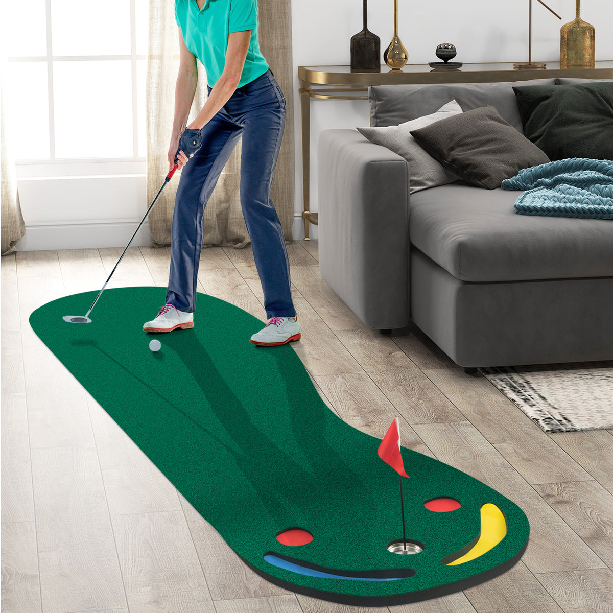 The putting green set placed on a wooden floor in a living room with a person putting