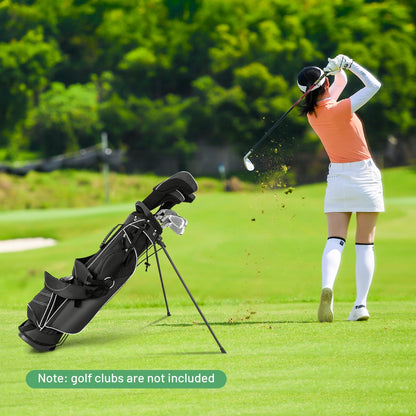 The golf bag standing on a green course while a woman plays a shot