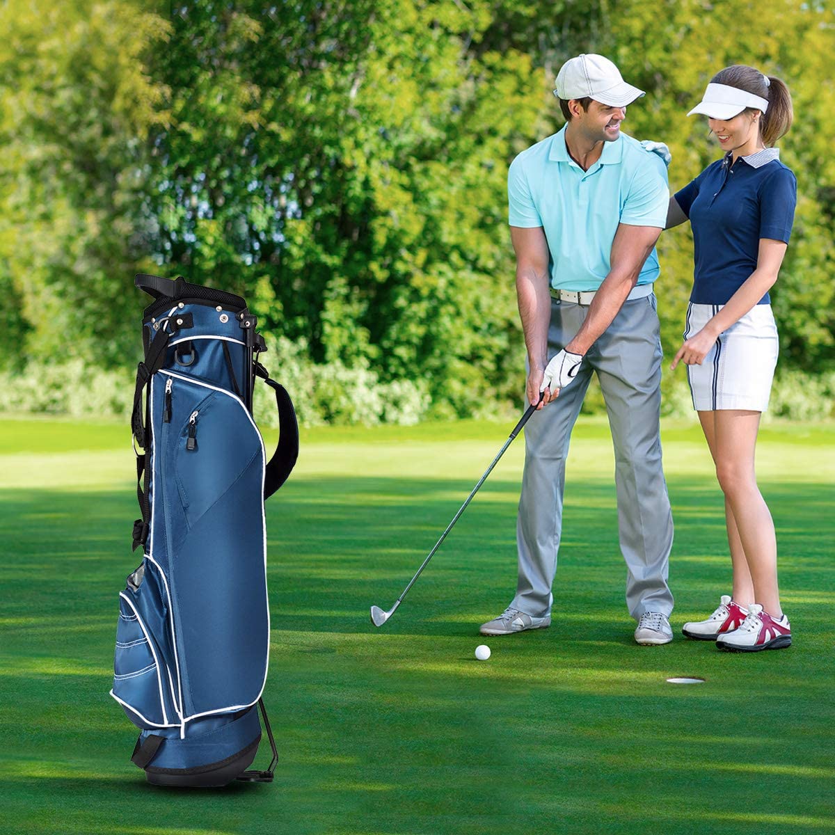 The navy golf stand bag on a golf course with a man and woman playing golf