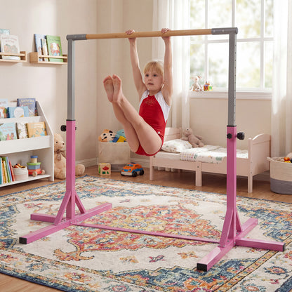 The pink gymnastics bar with a young girl performing a leg raise