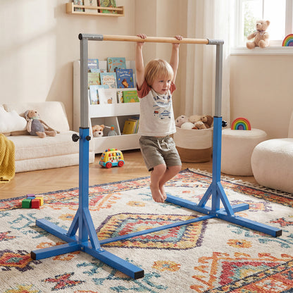 A young boy hangs from the horizontal bar in a child's playroom