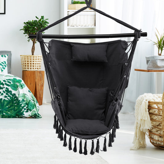 The grey hammock chair is shown indoors in a bright living room setting
