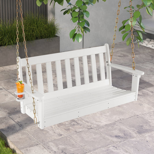 The white porch swing hanging on a patio with a glass of orange juice in the cup holder