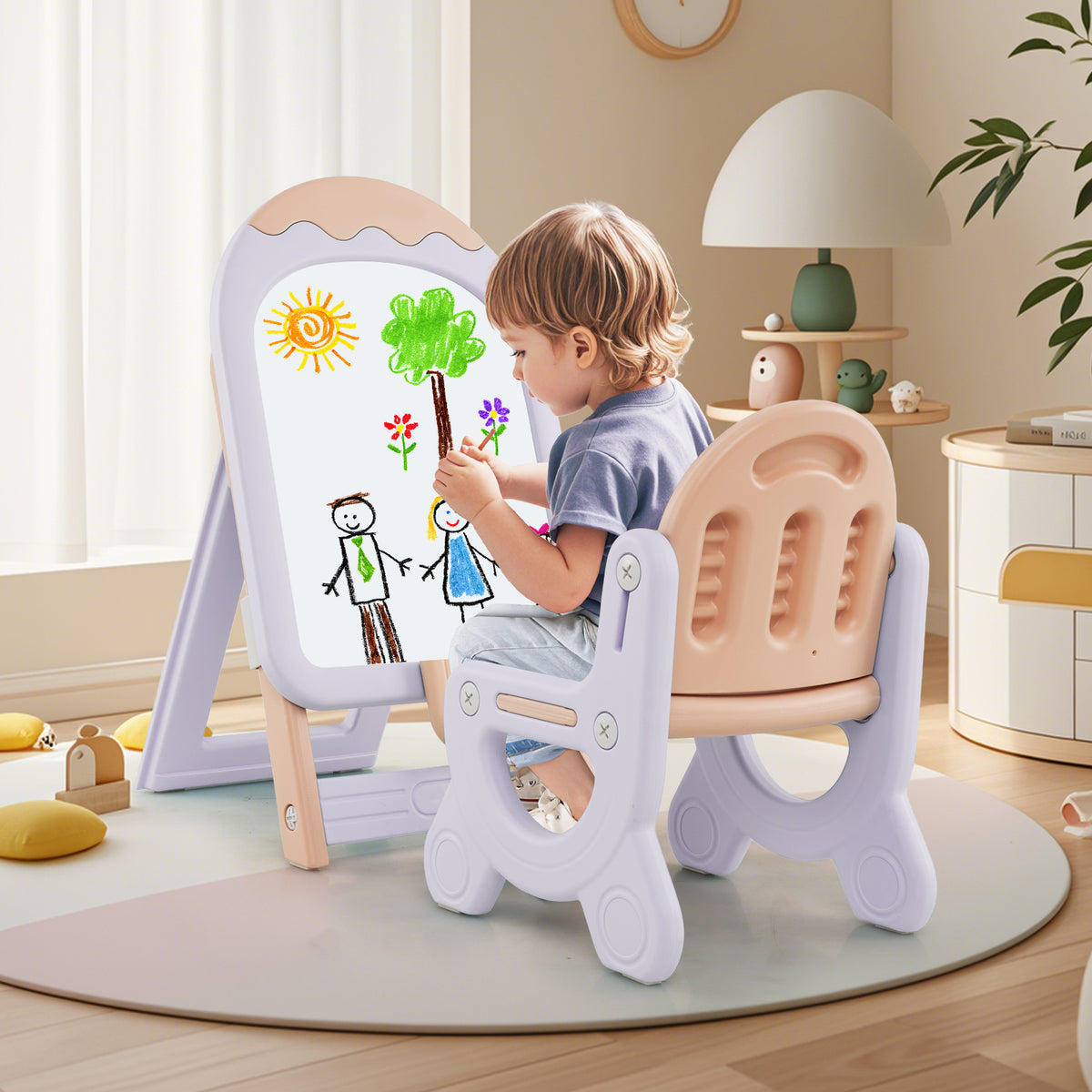 A child sits at the pink and purple kids art easel and draws a picture
