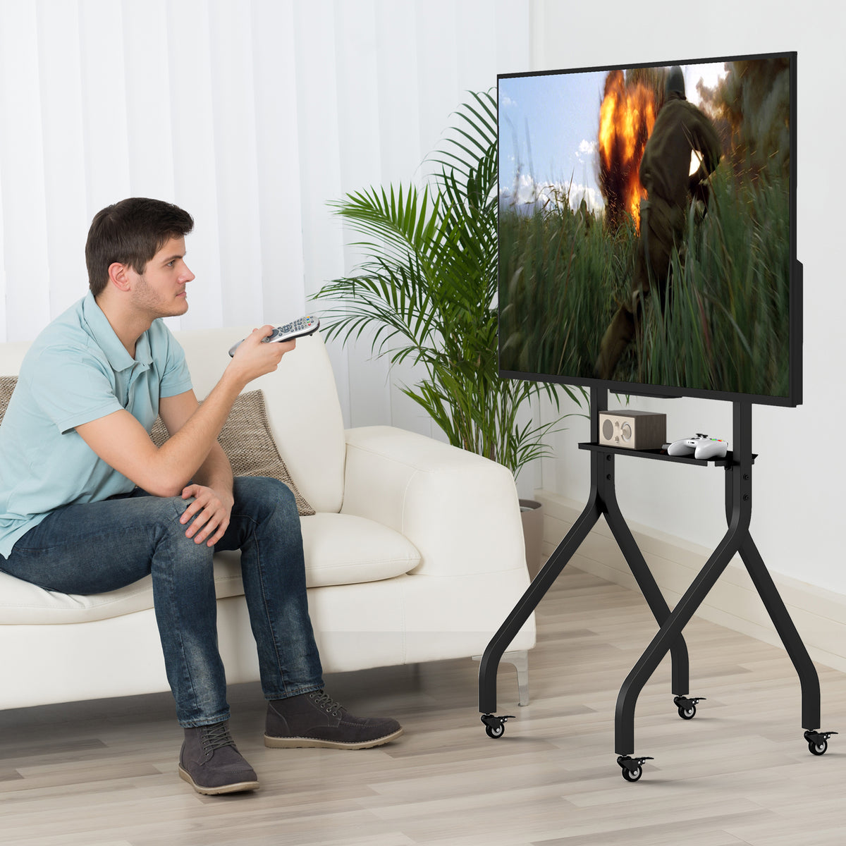 Man watching TV on the floor TV stand while sitting on a sofa