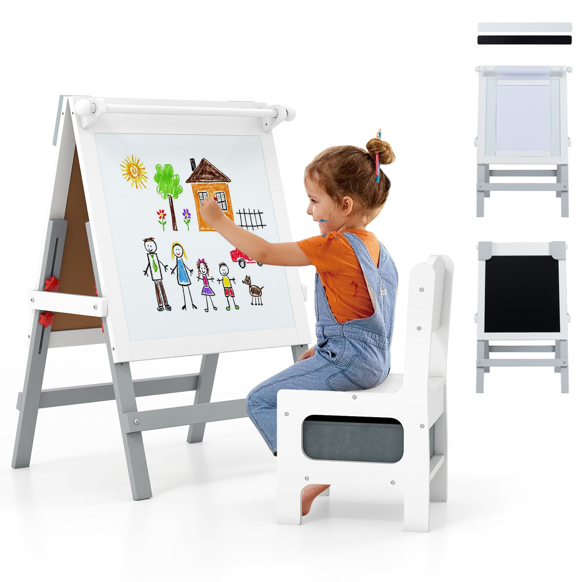 A young girl draws on the art easel, which is white with a chalkboard and paper holder