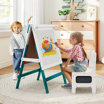 Two children paint and draw at the green and white art easel with a chair