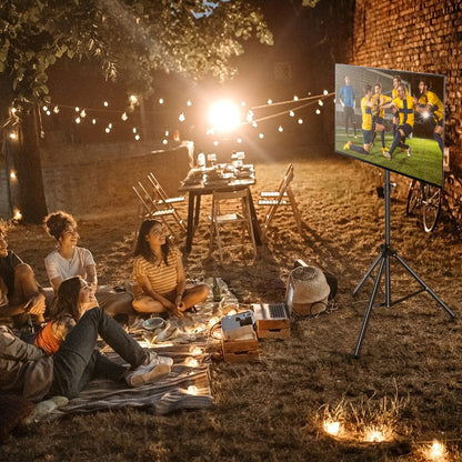 The black tripod display stand holding a television screen during an outdoor evening gathering