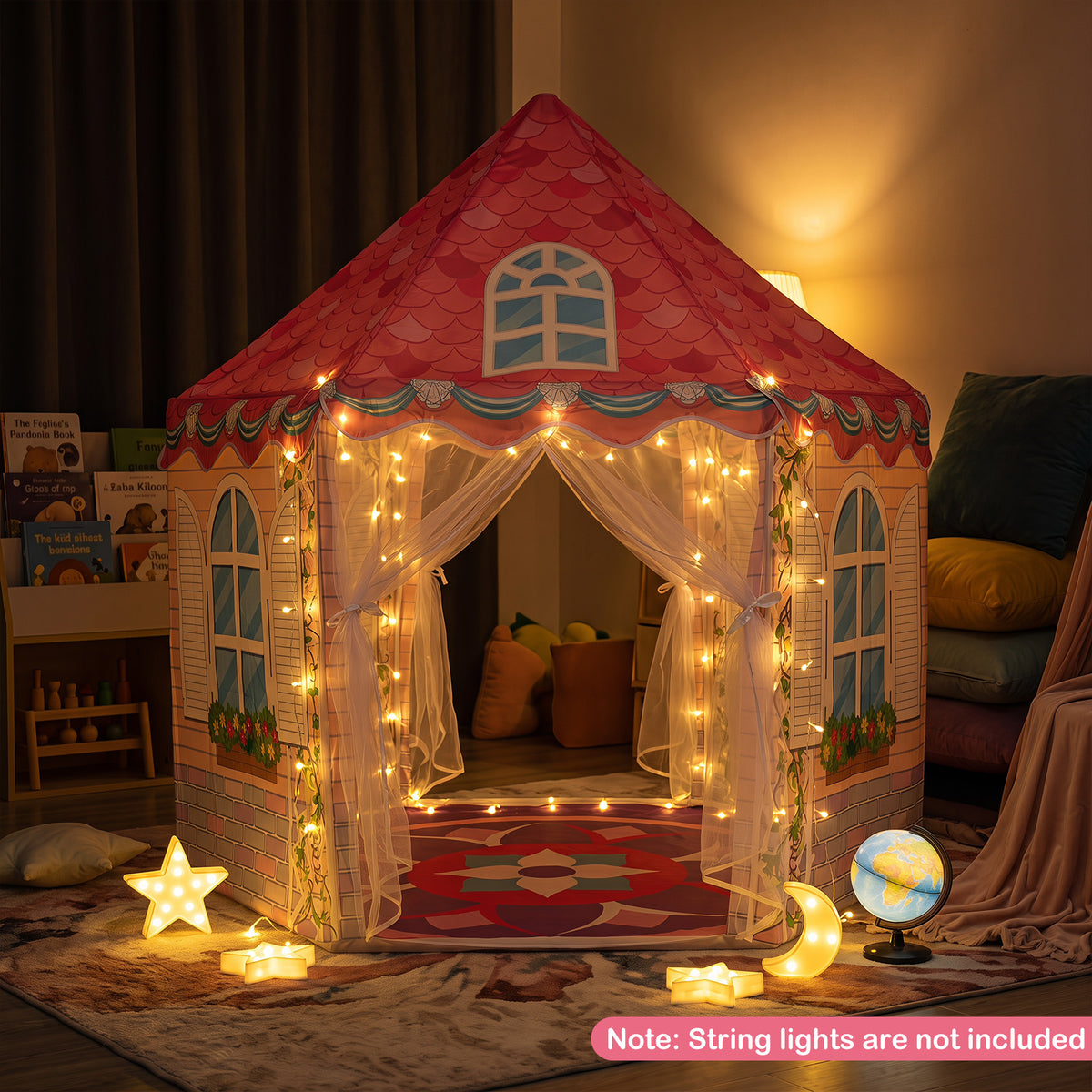 Pink hexagonal play tent decorated with fairy lights at night