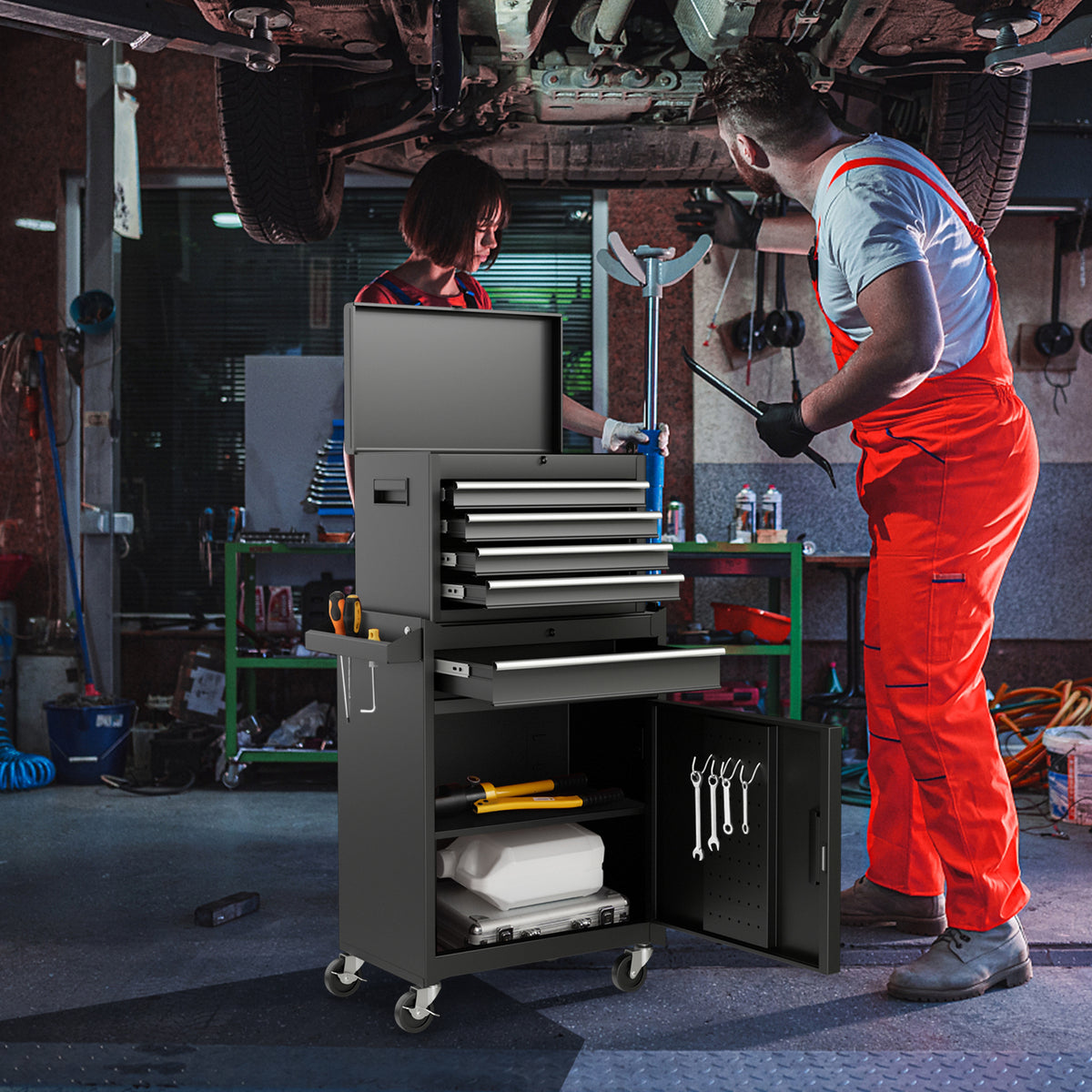 The garage storage unit with open drawers and doors in a busy workshop with mechanics