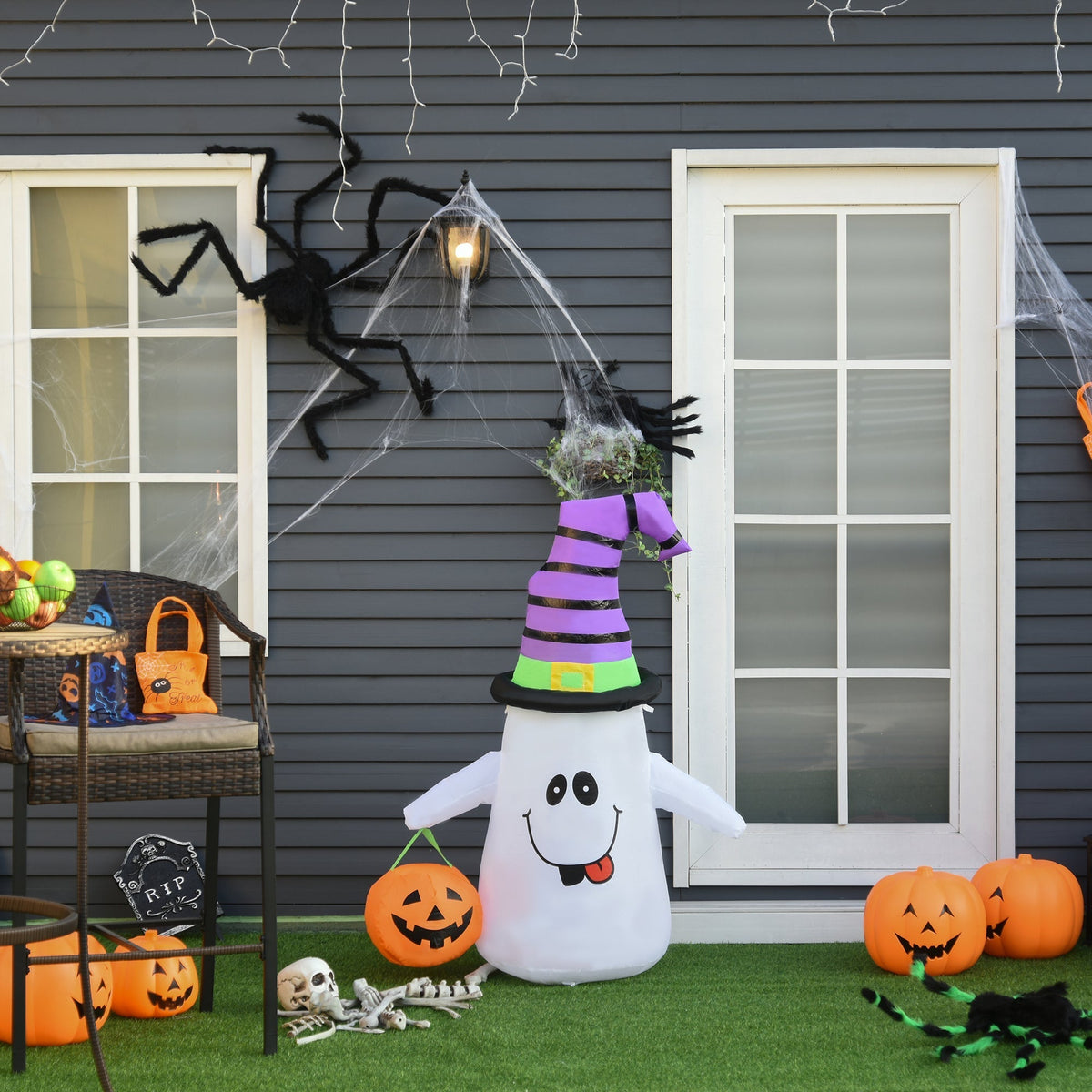 The Halloween inflatable decoration placed on a patio with other seasonal decorations