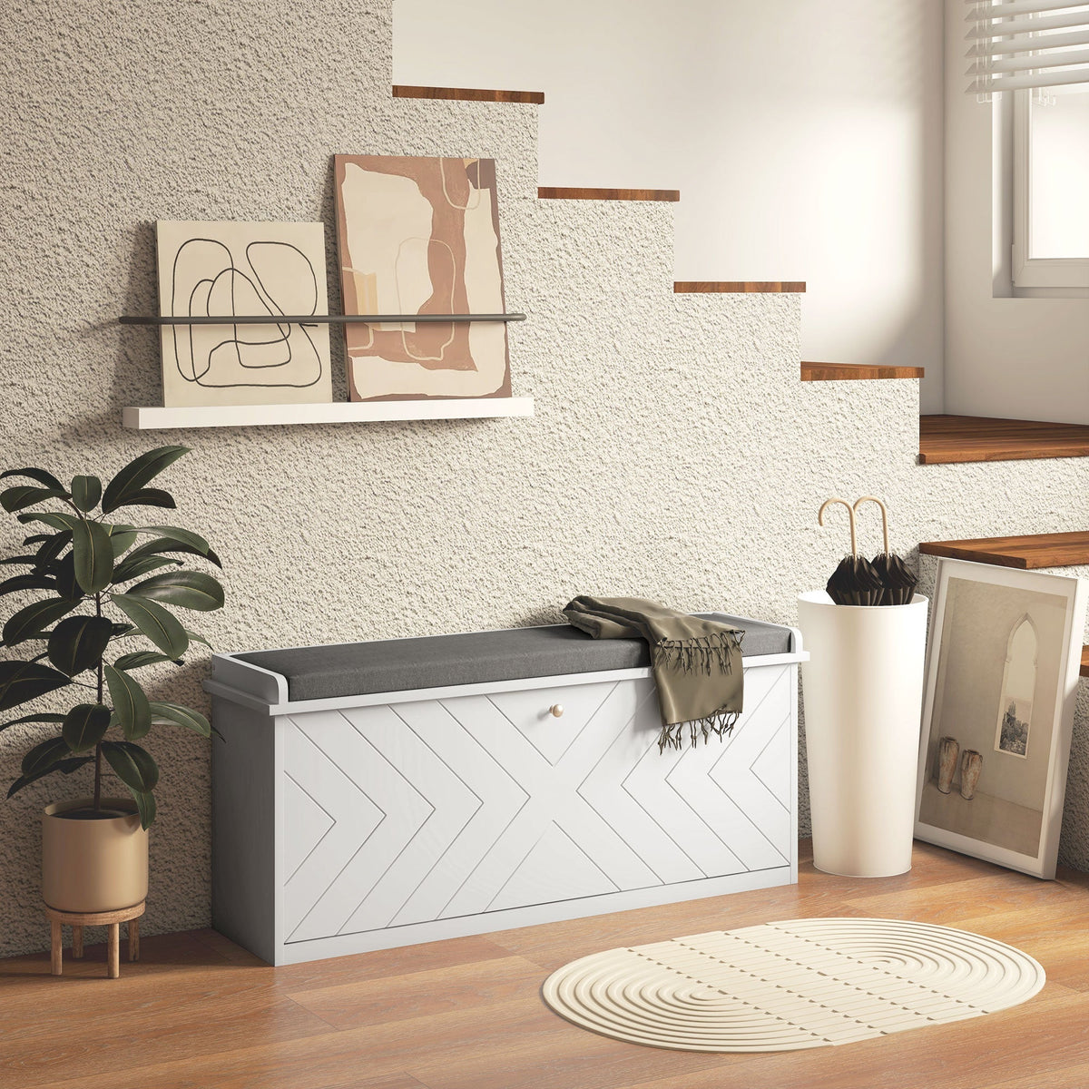 The shoe storage placed in a hallway next to a plant and stairs with a throw blanket on top