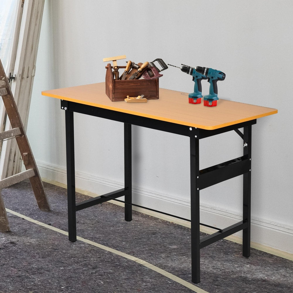 The garage work bench set up with tools on top and a ladder nearby, showing its use as a craft table
