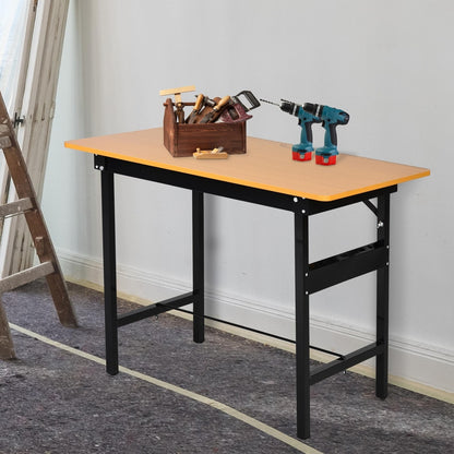 The garage work bench set up with tools on top and a ladder nearby, showing its use as a craft table