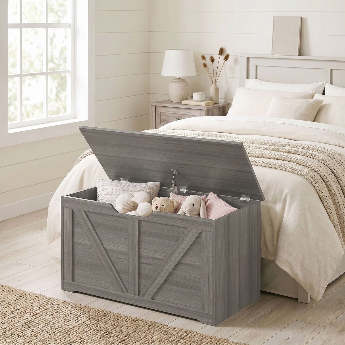The storage cabinet placed at the foot of a bed in a bedroom filled with various soft toys