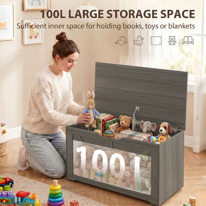 A woman sitting on the floor next to the storage cabinet filled with books and plush toys