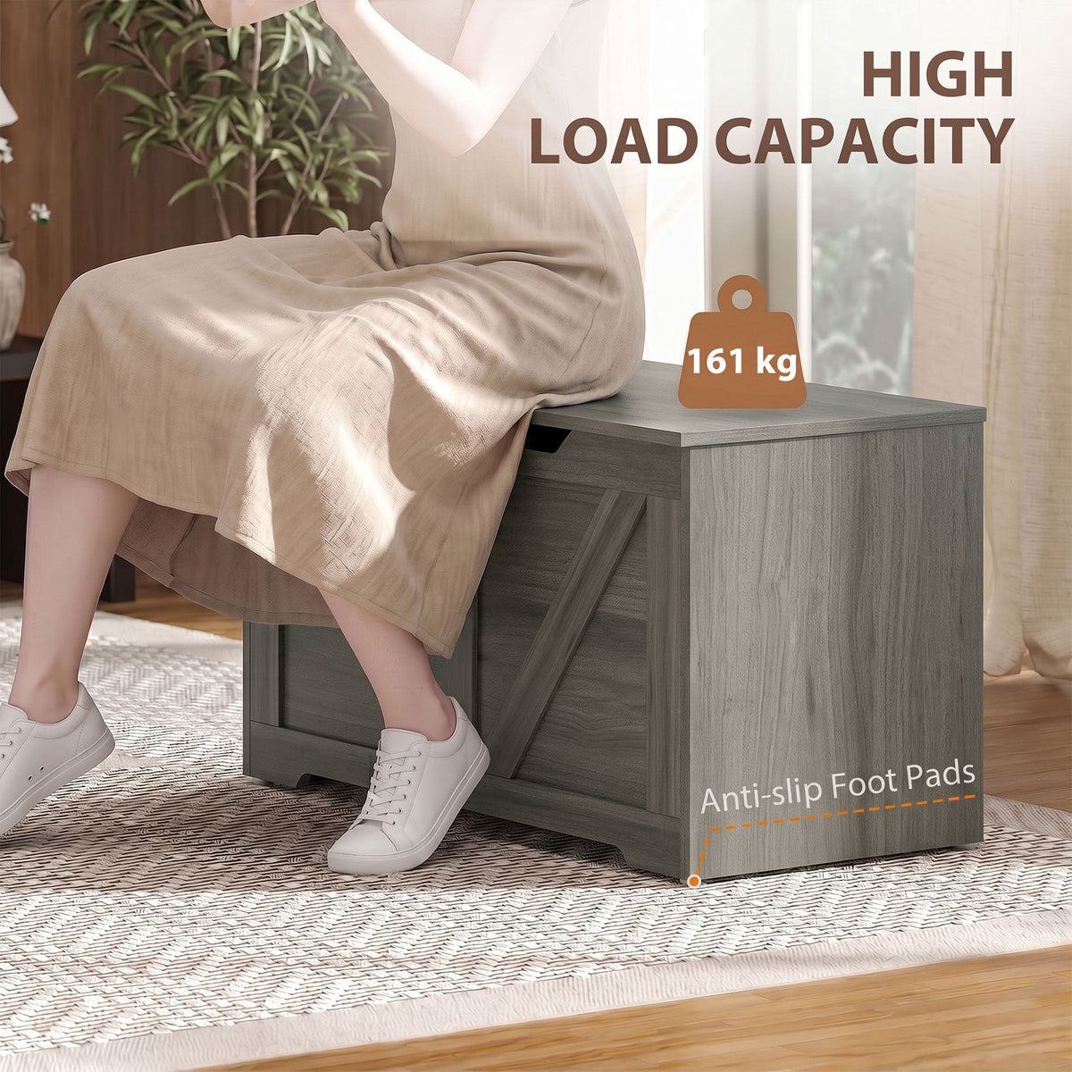 The storage cabinet being used as a seat by a person to demonstrate its high load capacity