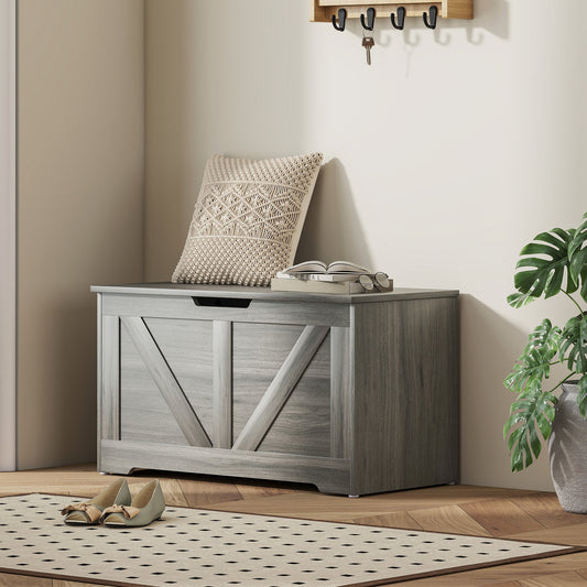The storage cabinet placed in a living room setting with a cushion and books on top
