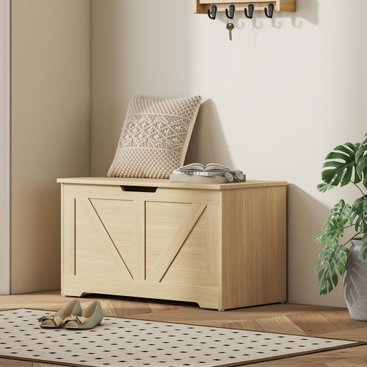 Storage cabinet in a hallway with a pillow and books on top and shoes nearby