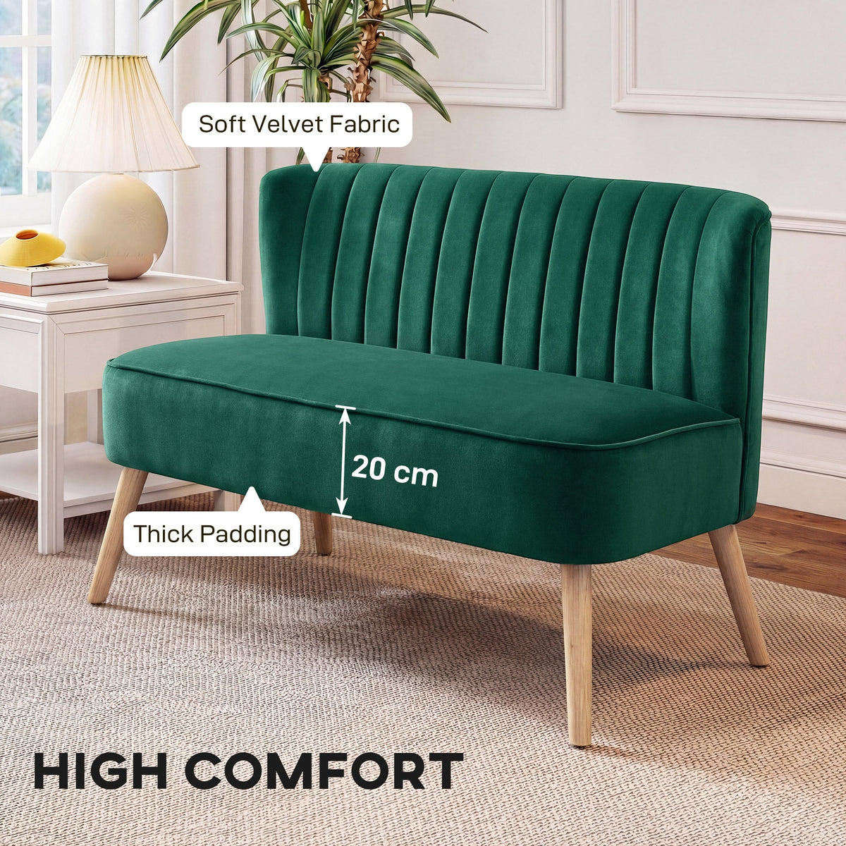 Close up of the dark green upholstered two-seater sofa showing thick padding and soft velvet fabric