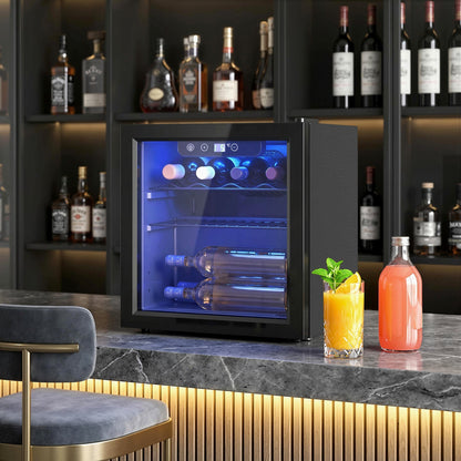 The drinks fridge placed on a kitchen counter with bottles inside and glasses of juice nearby