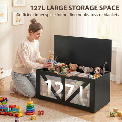 Woman placing toys into a large storage box with 127L capacity shown