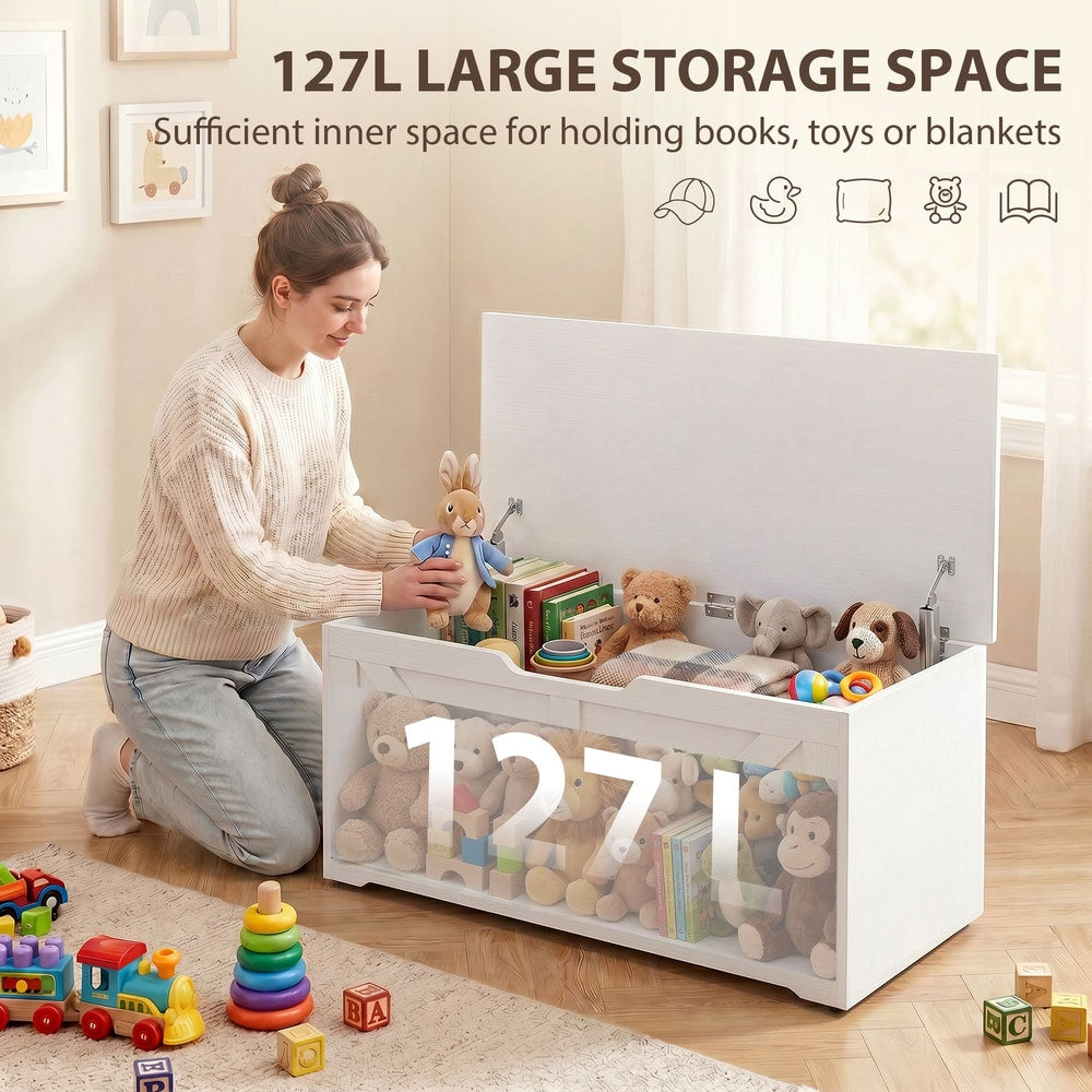 A woman packing toys into the large storage cabinet in a nursery