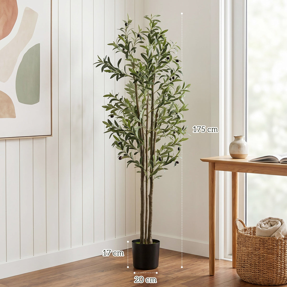 The artificial plant shown with height and width dimensions marked on a white wall