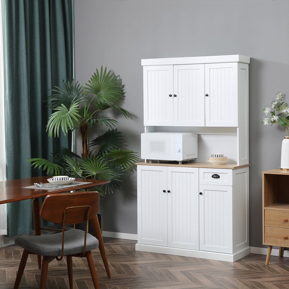 The kitchen cabinet is shown in a dining room setting with a microwave on the countertop