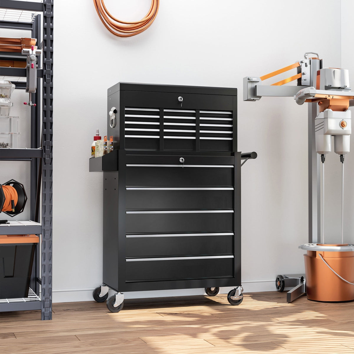 The black tool storage chest on wheels in a workshop setting with tools and equipment around it