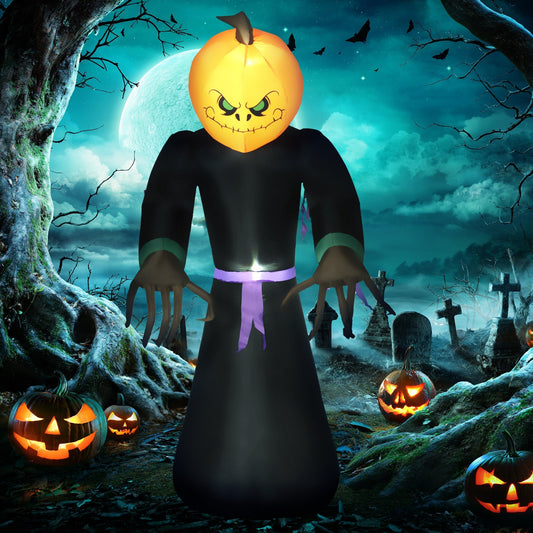 The Halloween inflatable ghost monster with pumpkin head in a spooky graveyard at night
