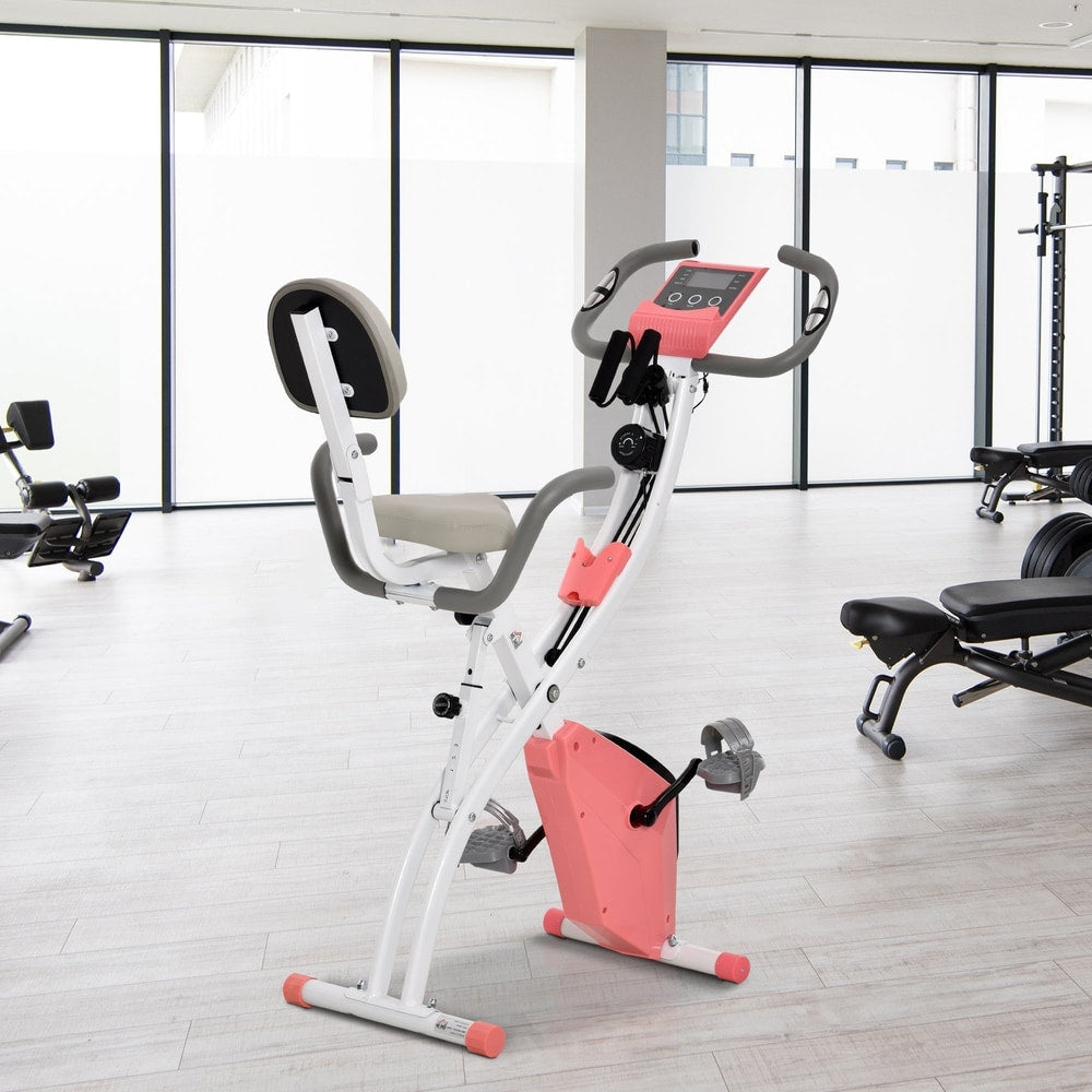 Pink exercise bike in a bright gym room with other equipment