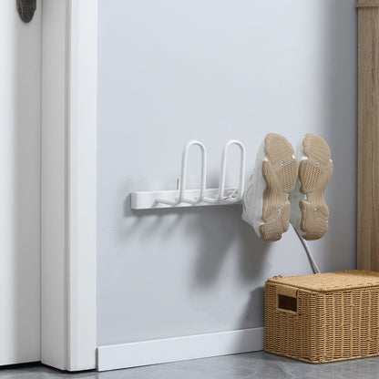 The electric shoe dryer mounted on a wall with a pair of trainers hanging on the drying arms