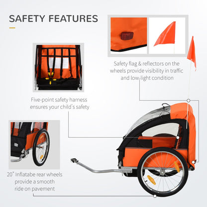 Close up of the safety harness and wheels of the orange and black child bike trailer